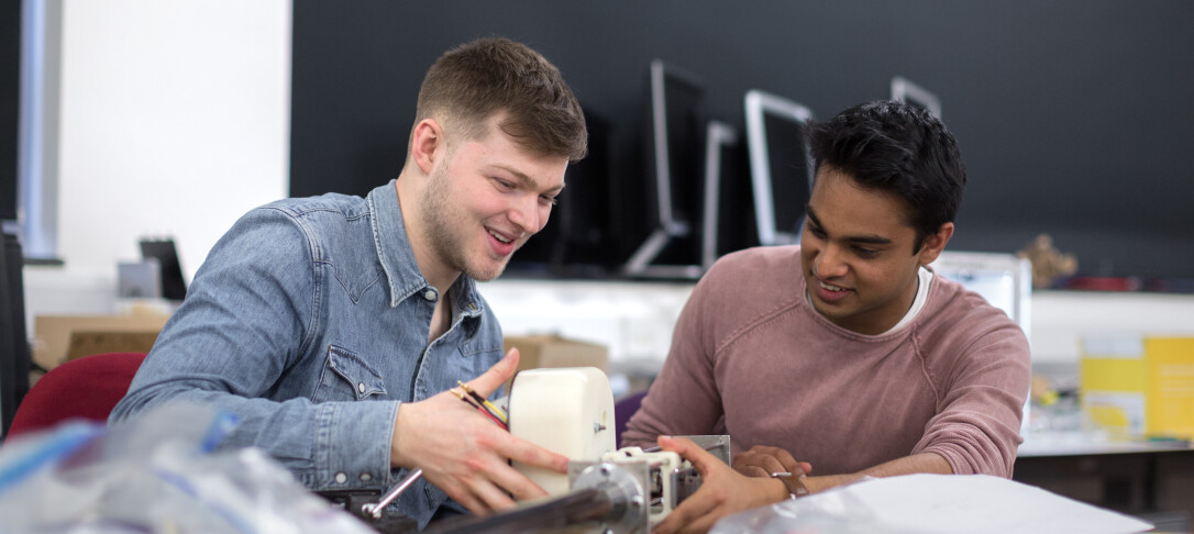 The Dyson School of Design Engineering Robot Intelligence Lab with Petar Kormushev UROP undergraduate students Joseph Terry (blue denim shirt) and Keshwyn Annauth working on their project of a slider for the legged robot project.
