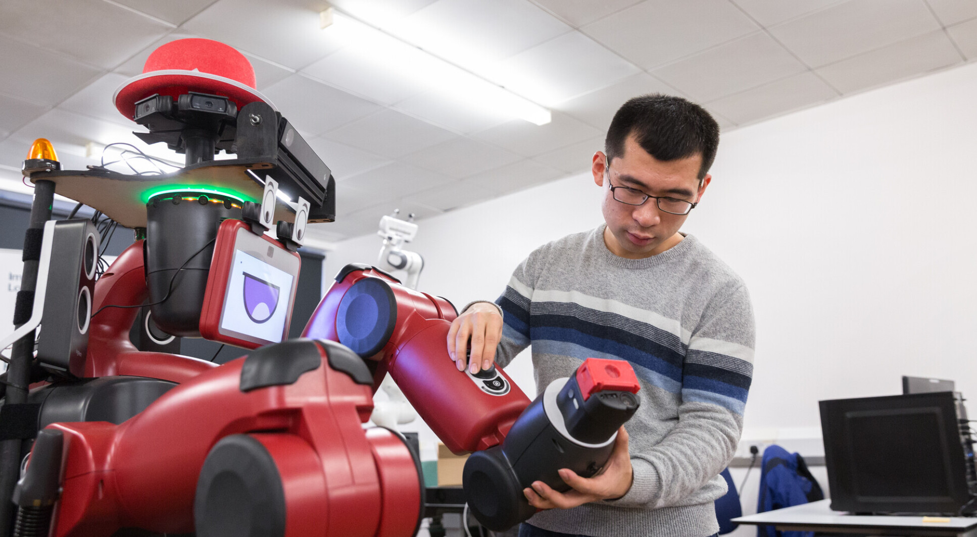 A PhD student working on a robot at Imperial's Robot Intelligence Lab. 