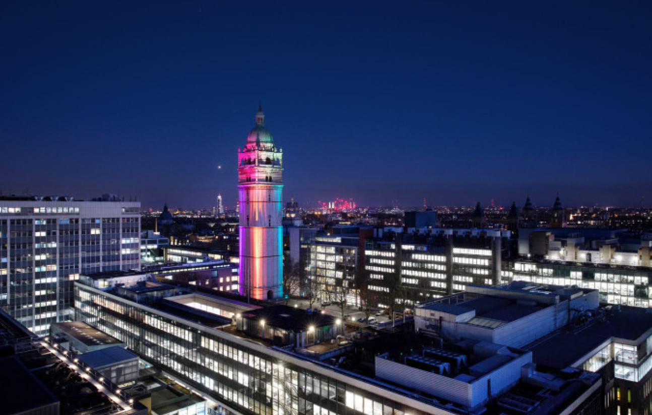 The Queen's Tower lit up at night with rainbow colours