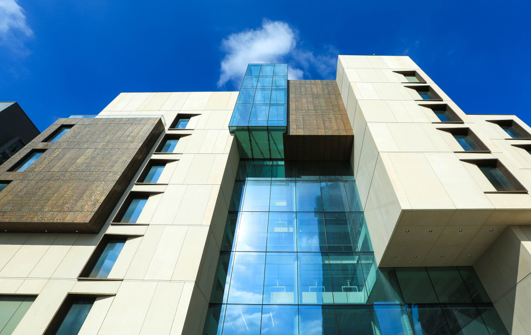 The exterior of the Molecular Sciences Research Hub building against a bright blue sky