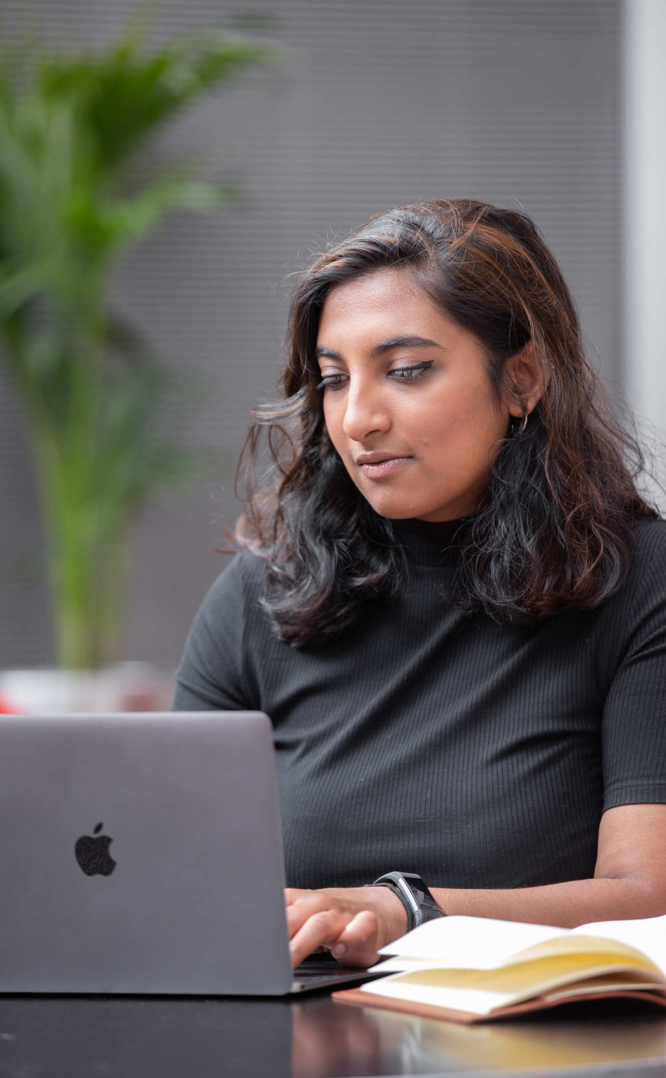 Anita Chandran sits at a laptop