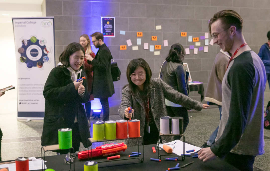 A member of the public plays at an interactive Infectious arcade exhibit