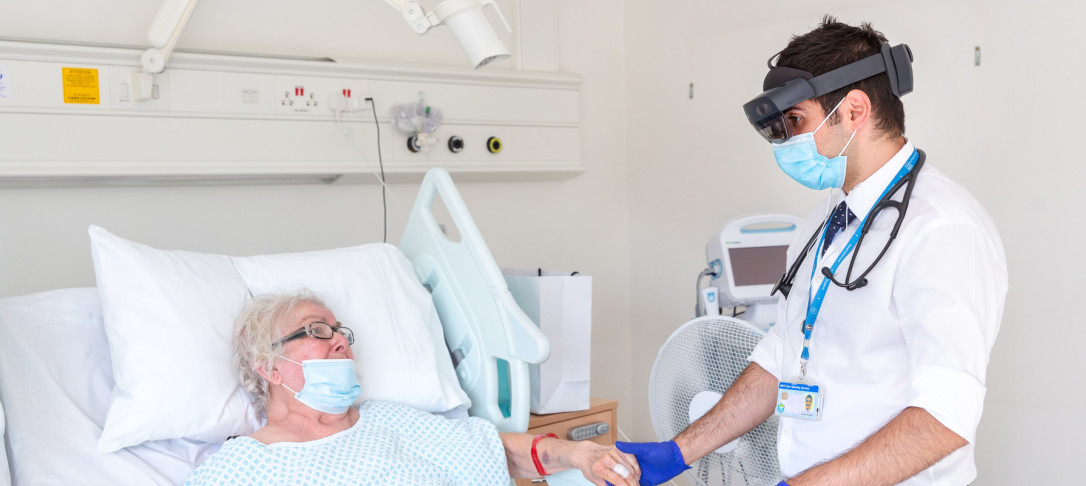 Physician using Hololens virtual headset with a patient