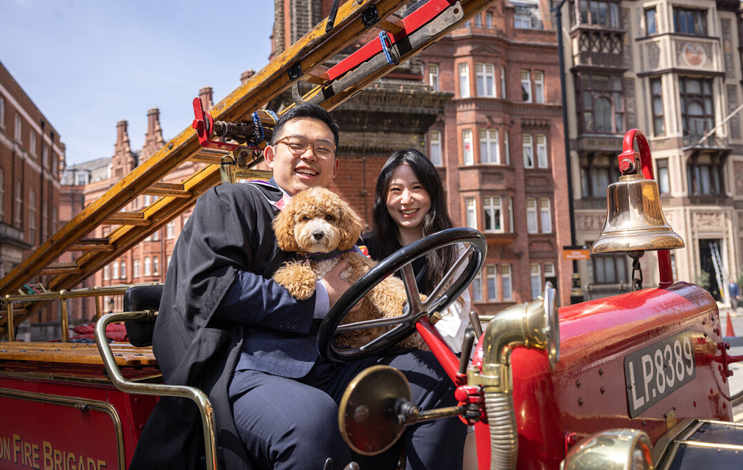 Two students and a dog on fire engine and a mascot "Jezabel"