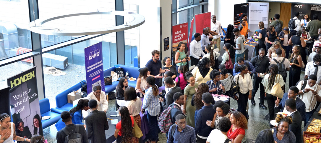 Lots of people at the Black Graduate Careers Conference exhibition taken for an elevated point of view