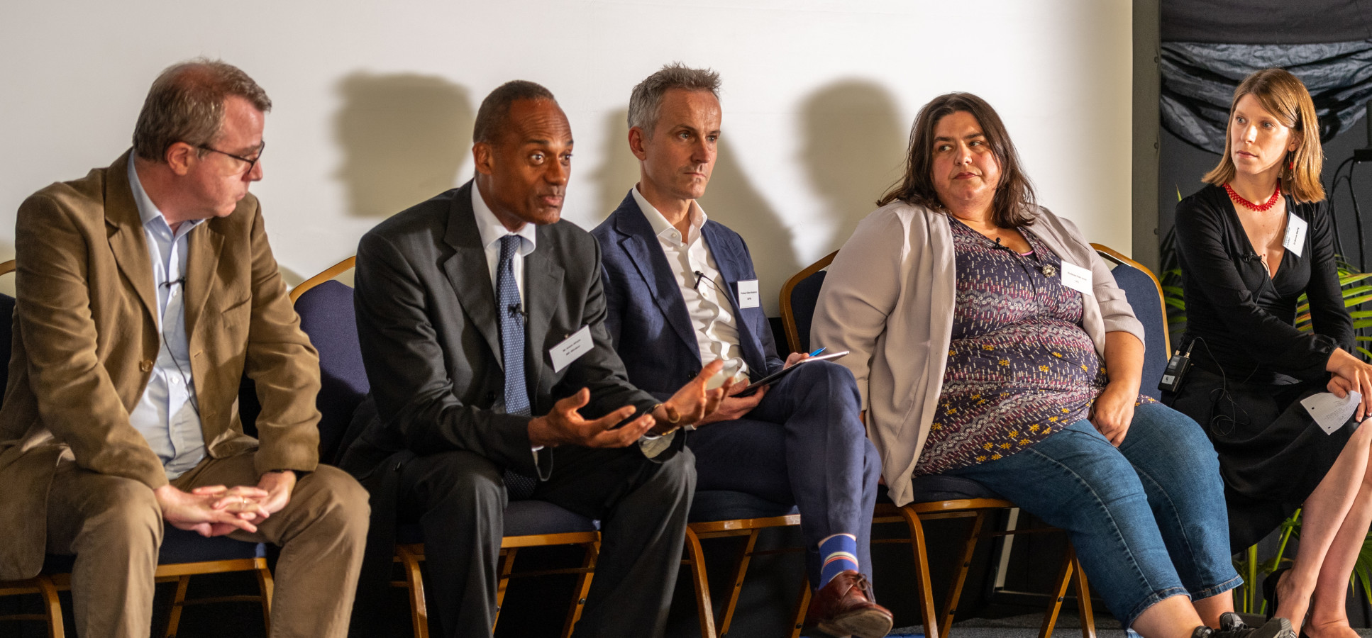 The panel engage in a lively discussion on stage