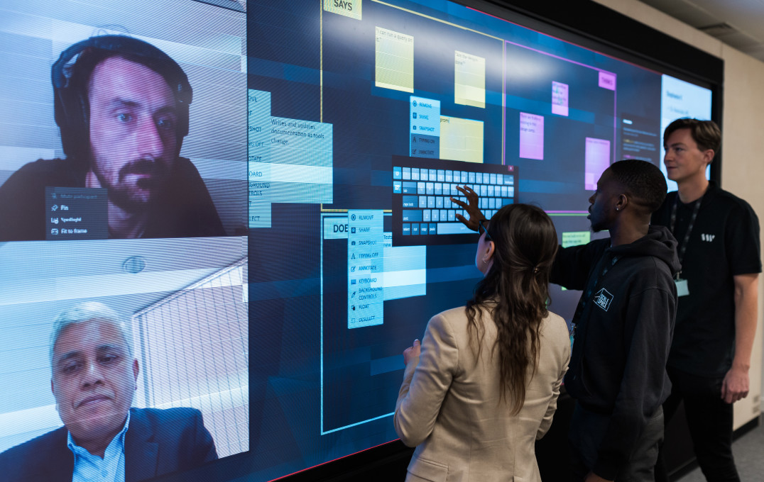 People making use of the large interactive screen at Scale Space