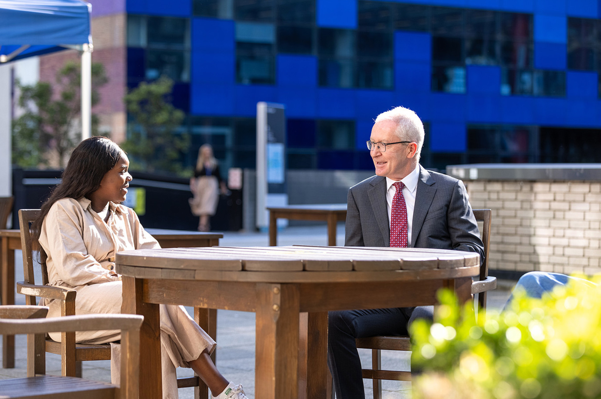 Professor Hugh Brady talking to a member of staff on campus