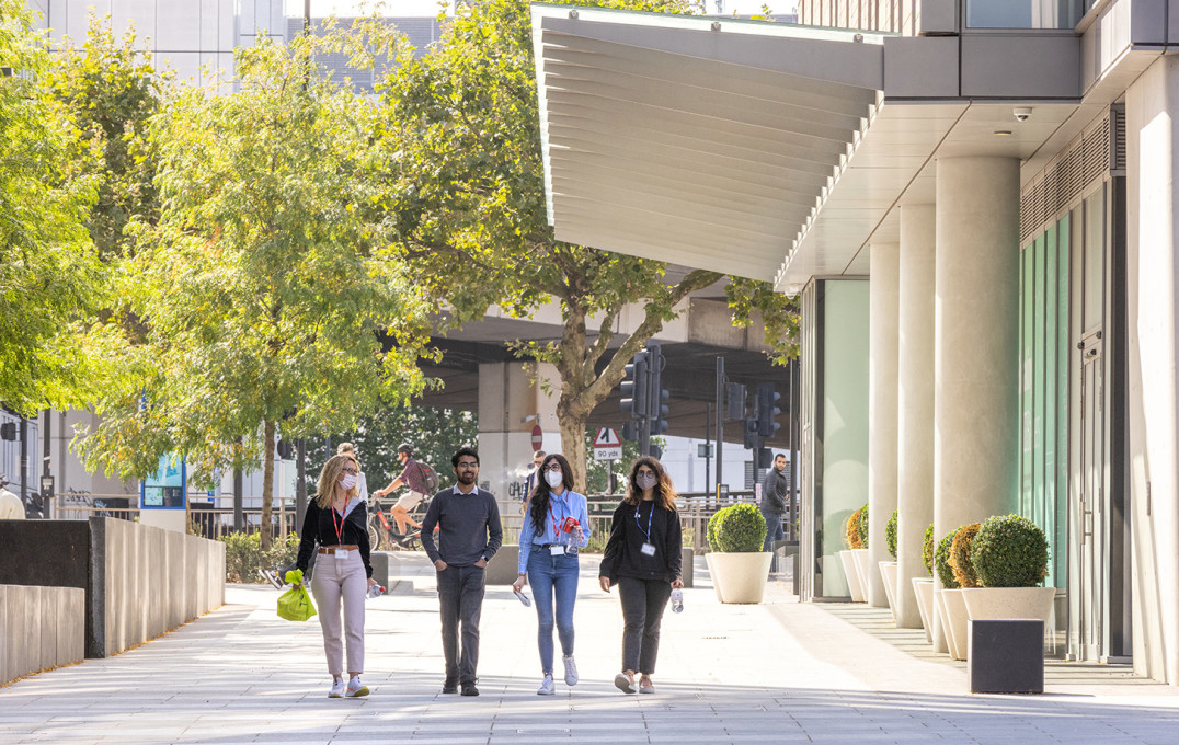 Students walking between buildings on the White City campus