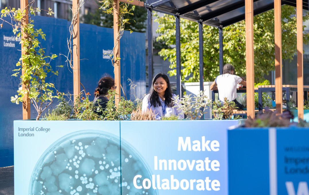 Staff and students enjoy a coffee outside the White City campus buildings