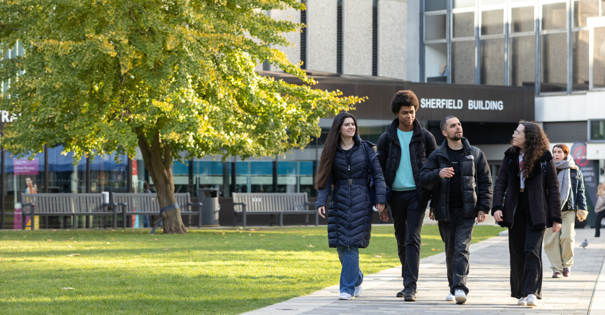 Four students walking through Dangoor Plaza on Imperial's South Kensington campus.