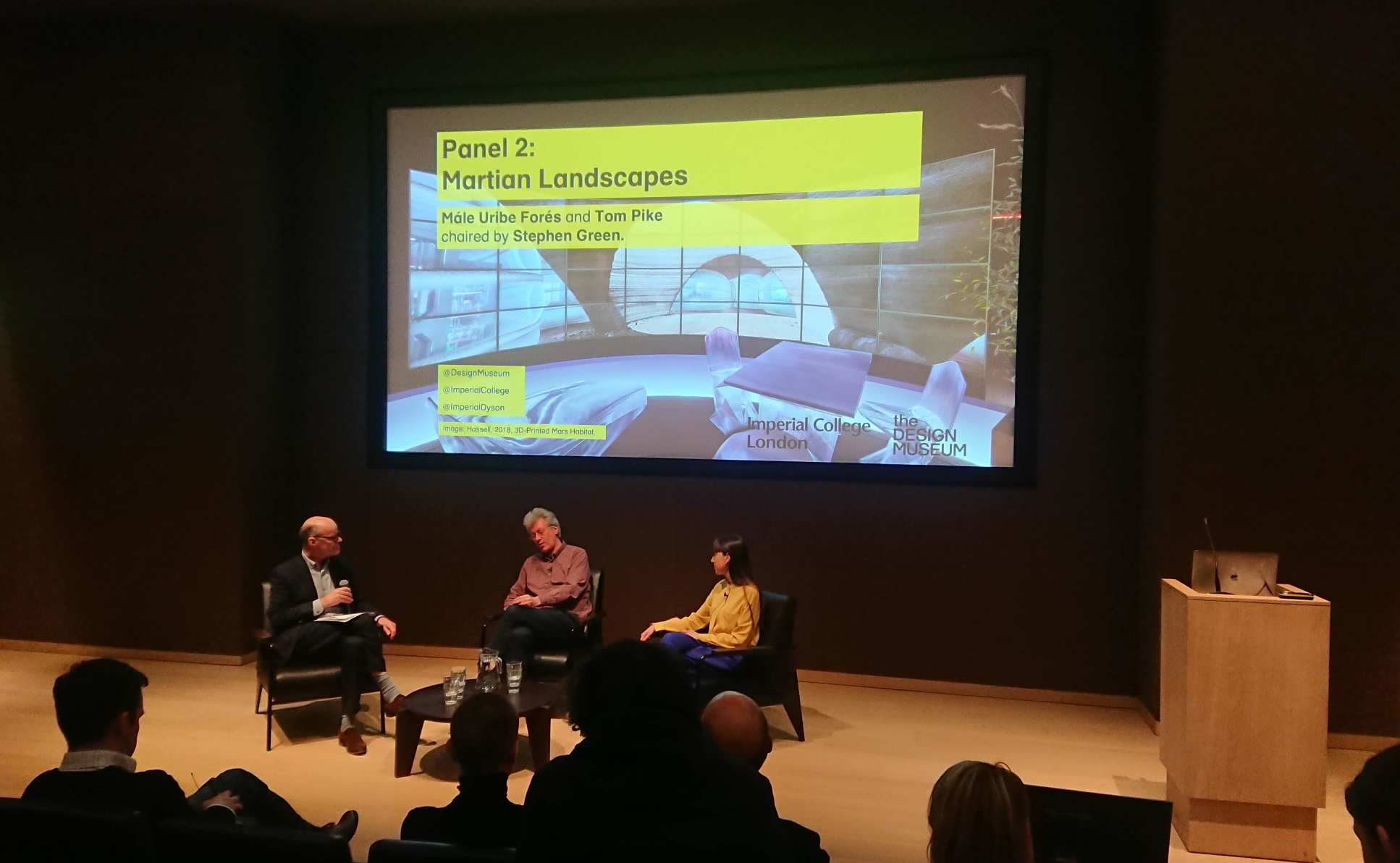 People sitting on a panel on a stage