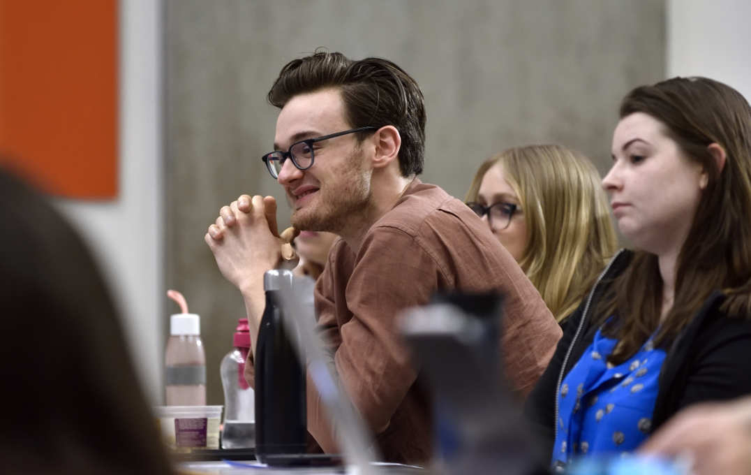 Student audience member smiling