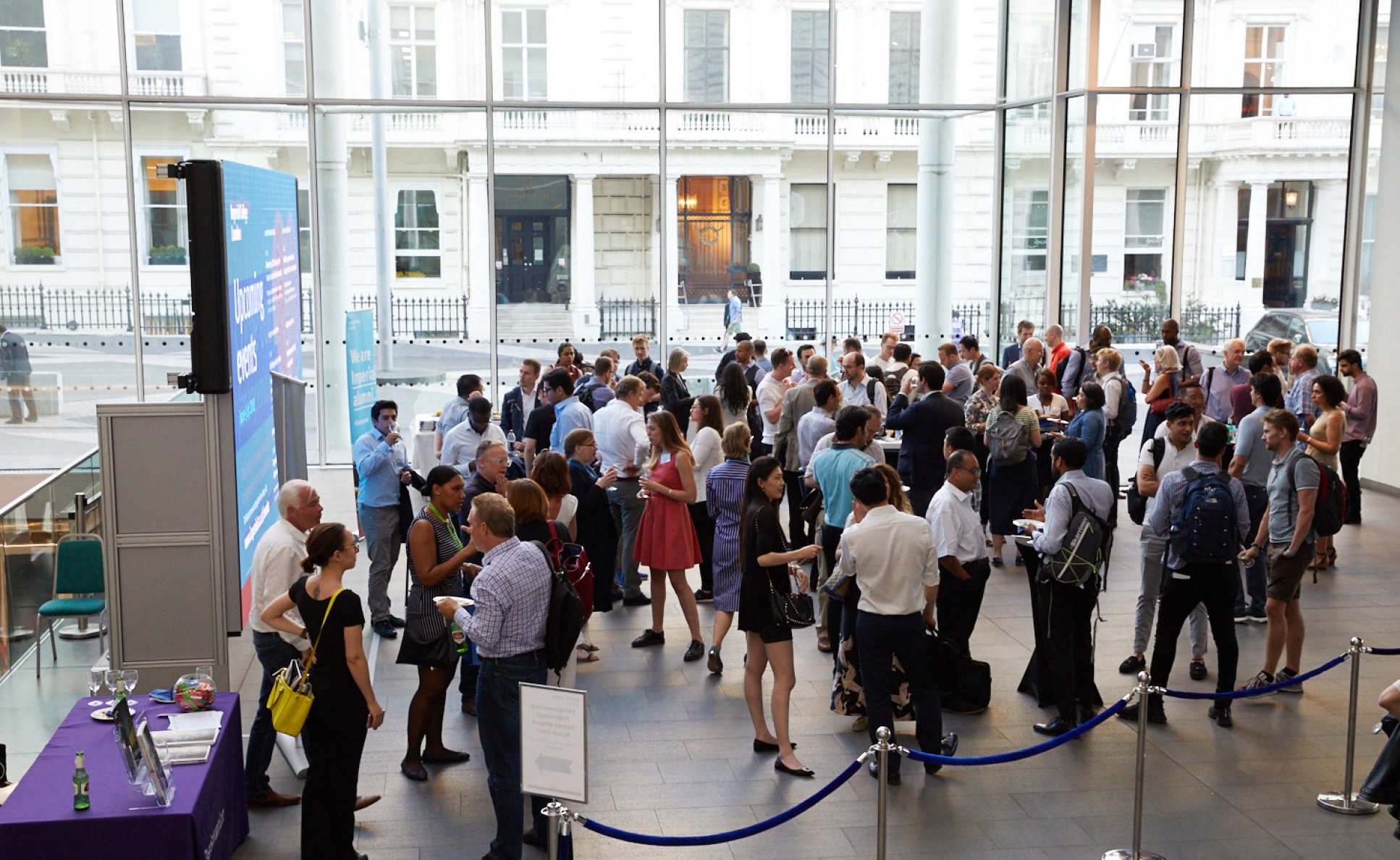 Alumni networking in the College main entrance