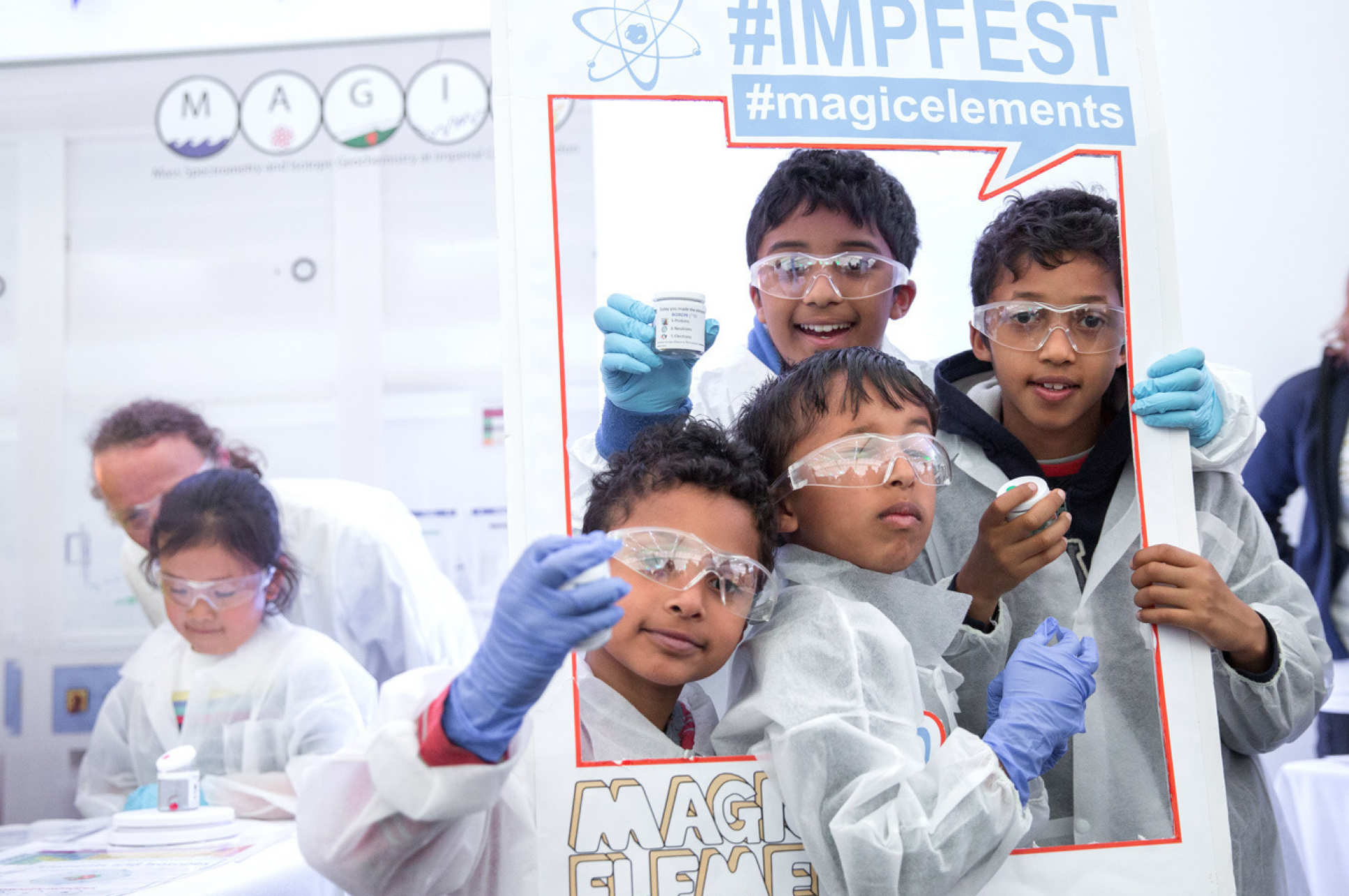 four boys in lab coats and goggles