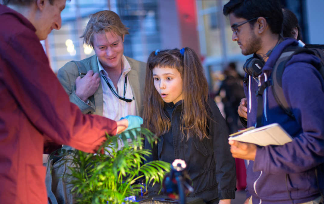 A young girl looks interested in a science exhibit