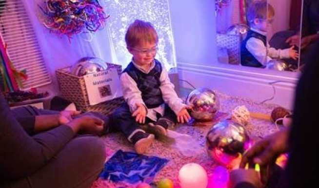 Child sitting in a small room