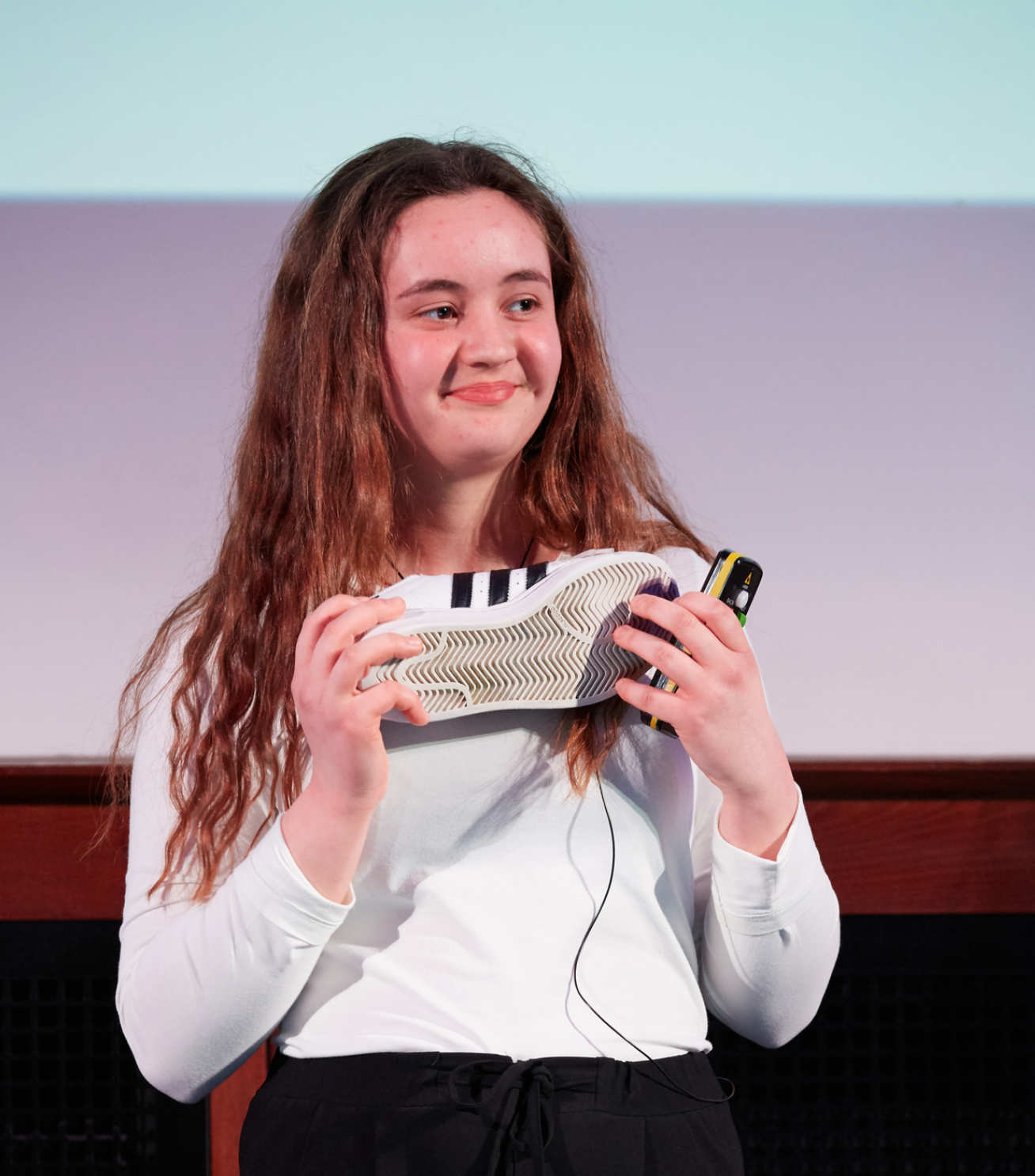 Cindy Xhebro holds her trainers