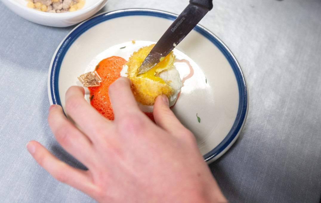 A plated dish featuring a deep-fried egg yolk