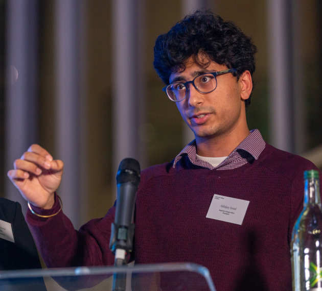 man speaking in front of microphone