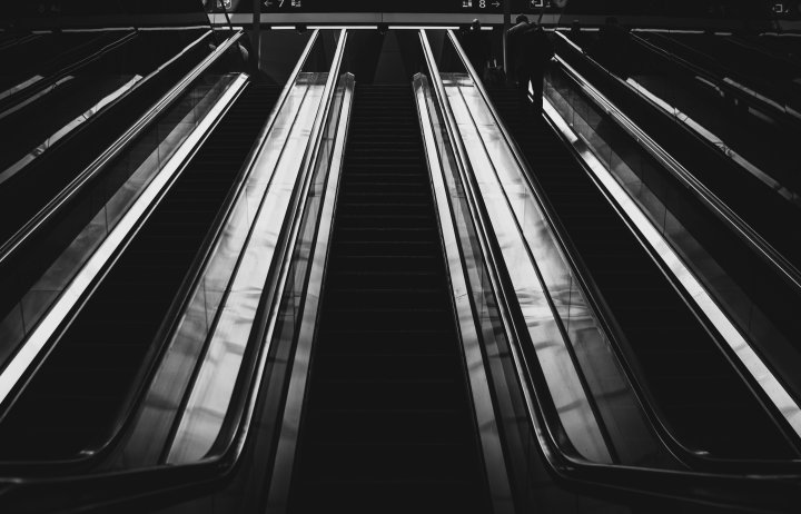 Photo of escalators in greyscale