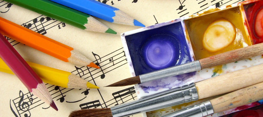Photo of arts materials - colouring pencils, paint, paint brushes, song sheet