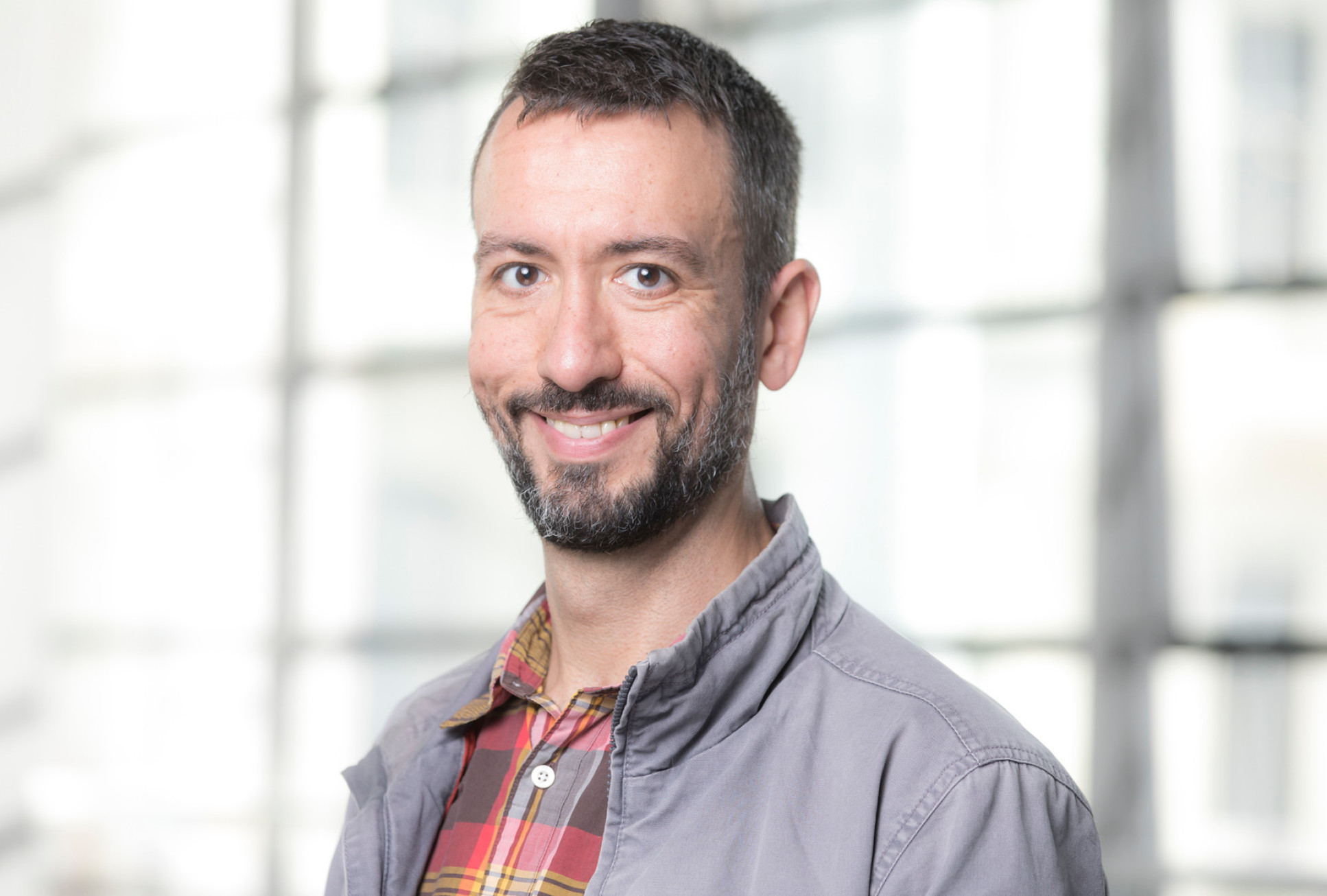 Smiling white man with beard in casual clothes