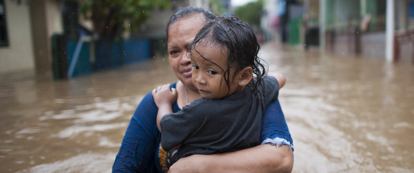 Woman and young child surrounded by floodwater