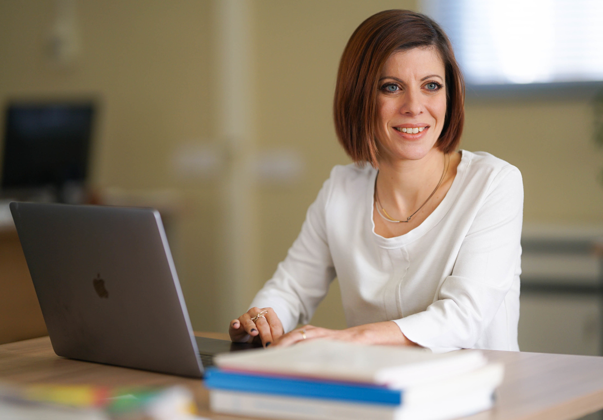 woman works on laptop smiling