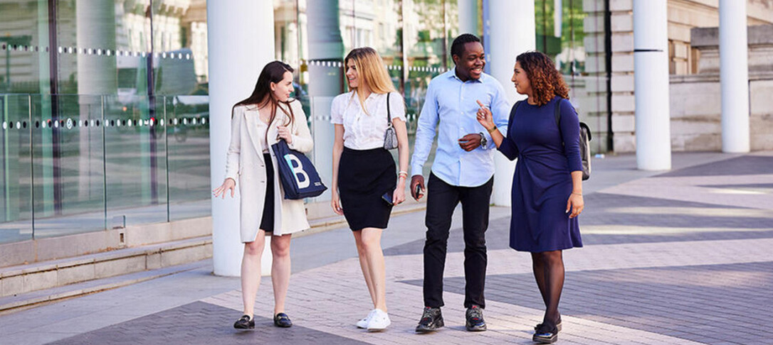 A group of students walking through the Imperial campus