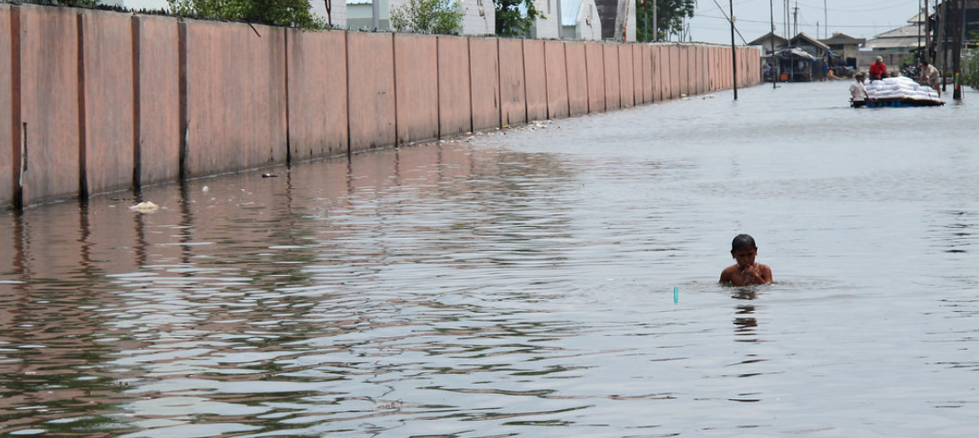 Photograph of young boy in flooded area