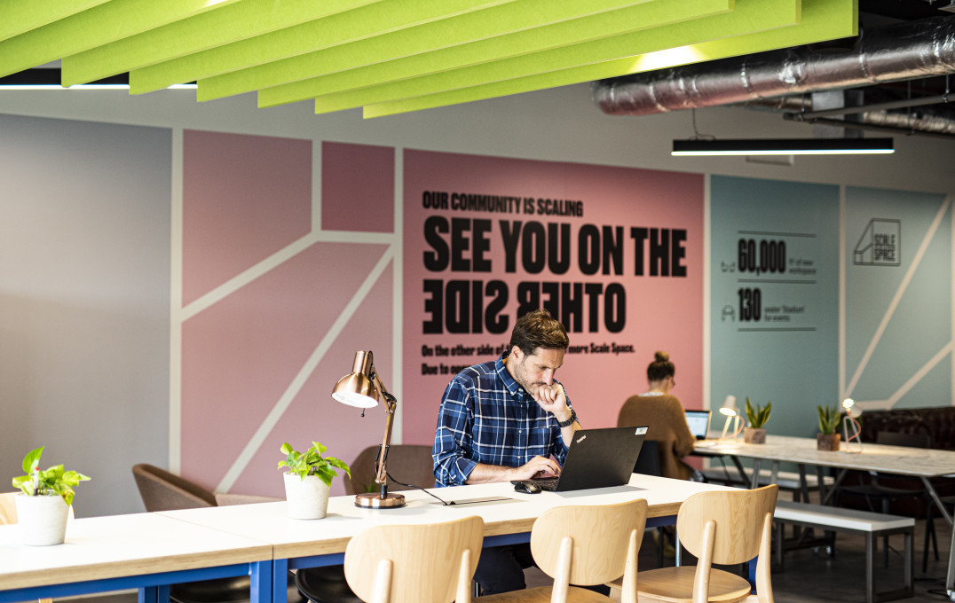 People working at cafe tables in the Scale Space reception