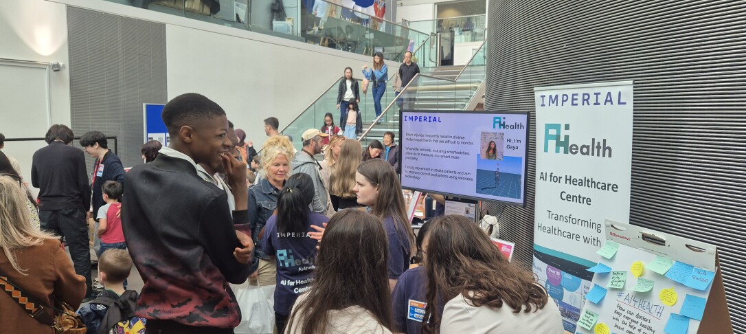 Group of people standing in front of stand and talking to each other