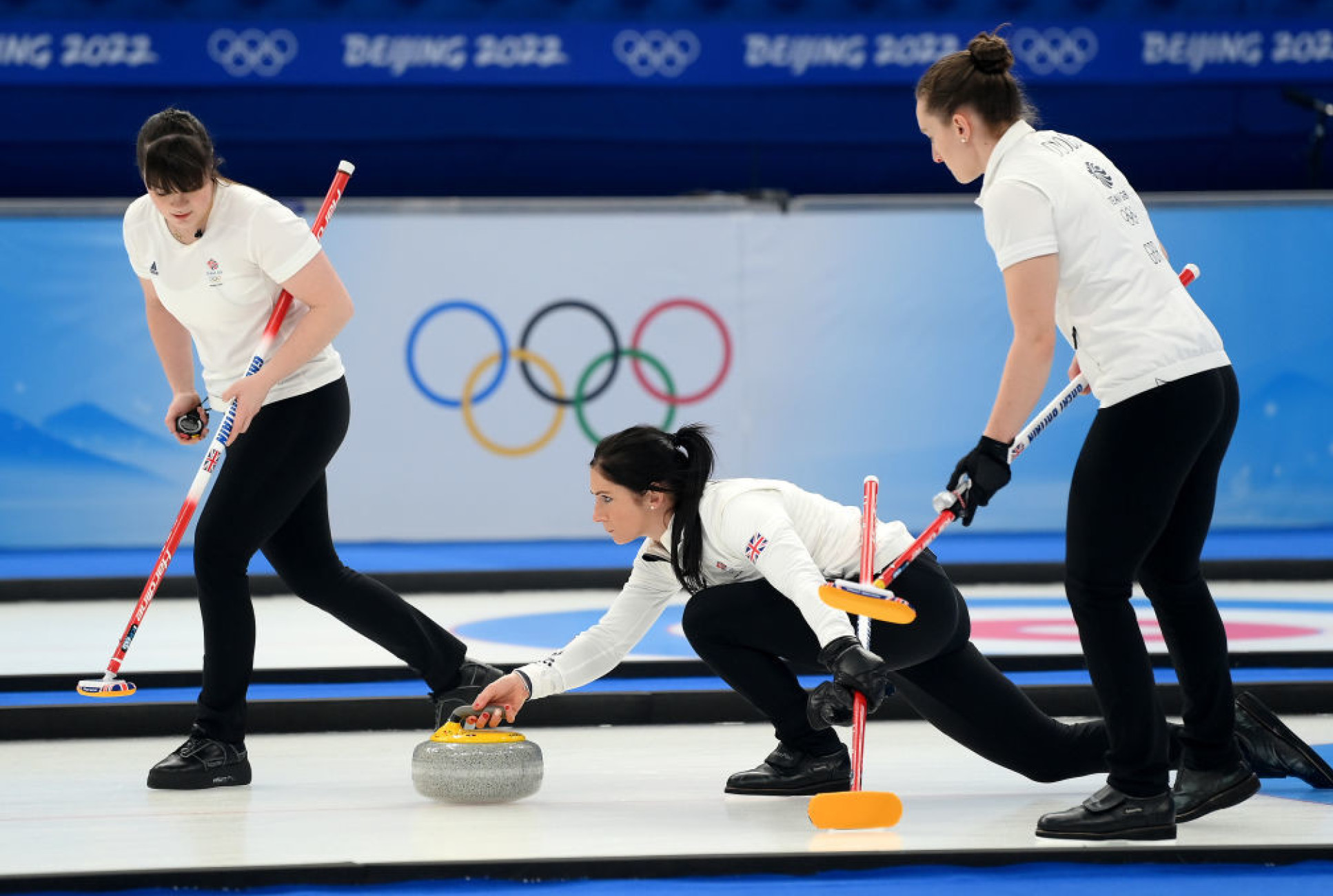 a curling match with three women