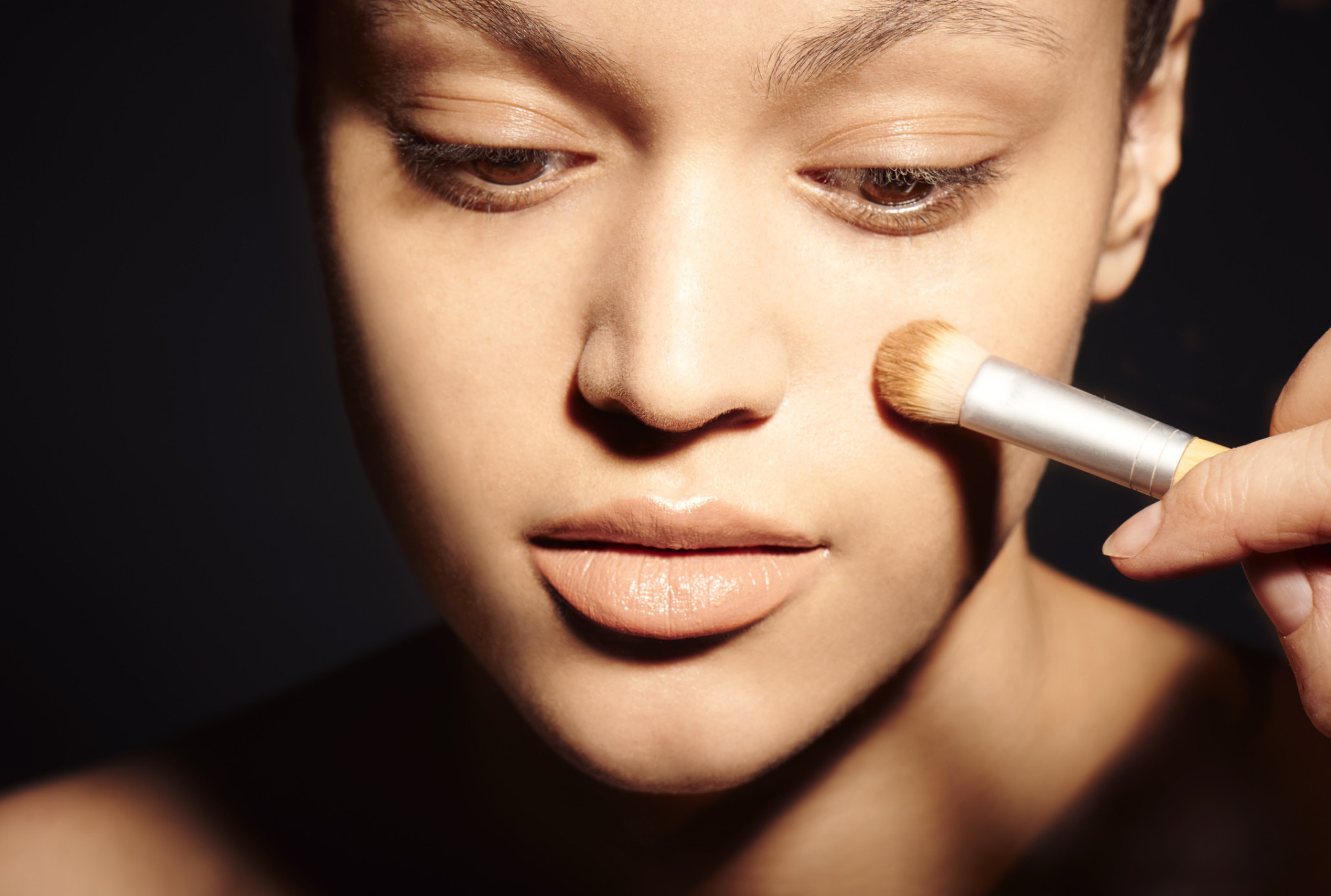 Woman applying make up with brush