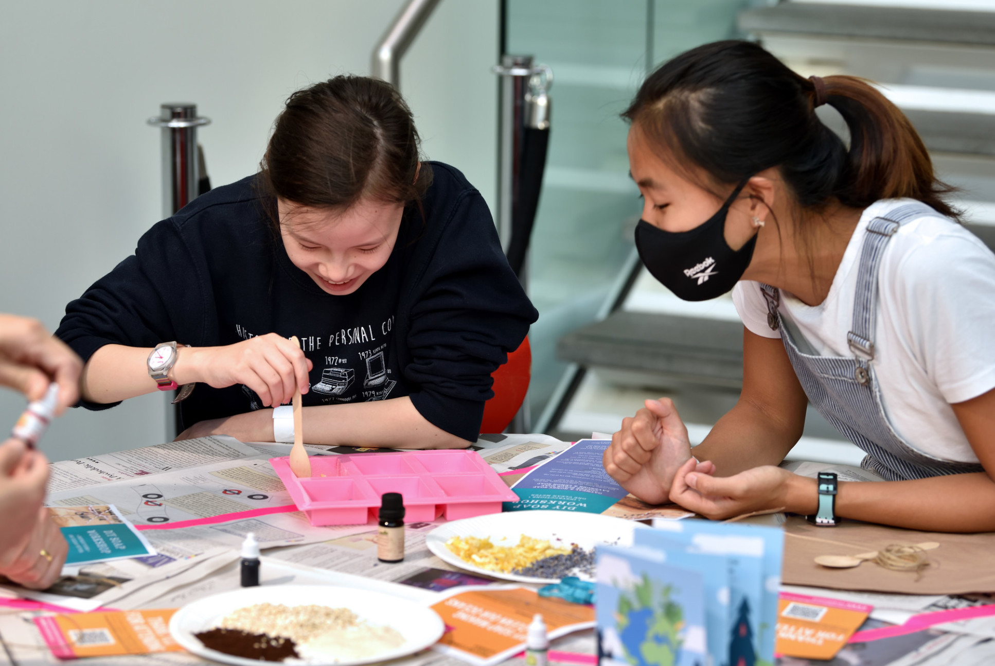 Two girls making soap in a workshop