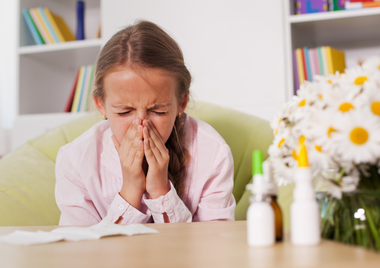 A young person sneezing
