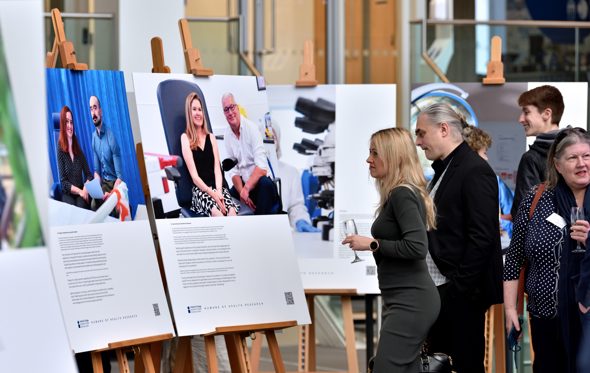 Guests viewing Humans of Health Research exhibition photographs