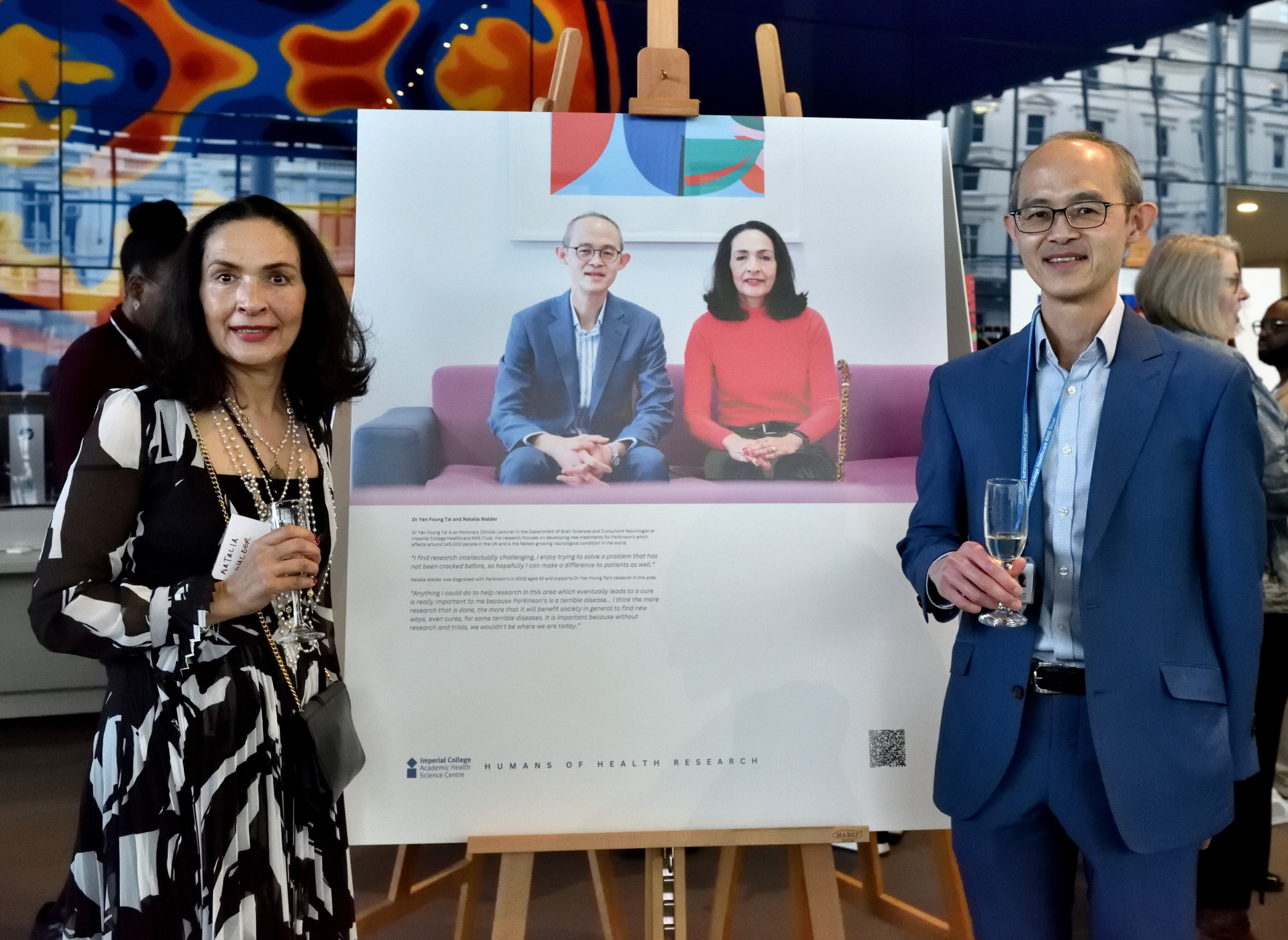 Dr Yen Foung Tai and Natalia Walder standing by their portrait