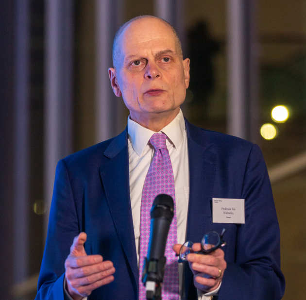 man speaking in front of microphone