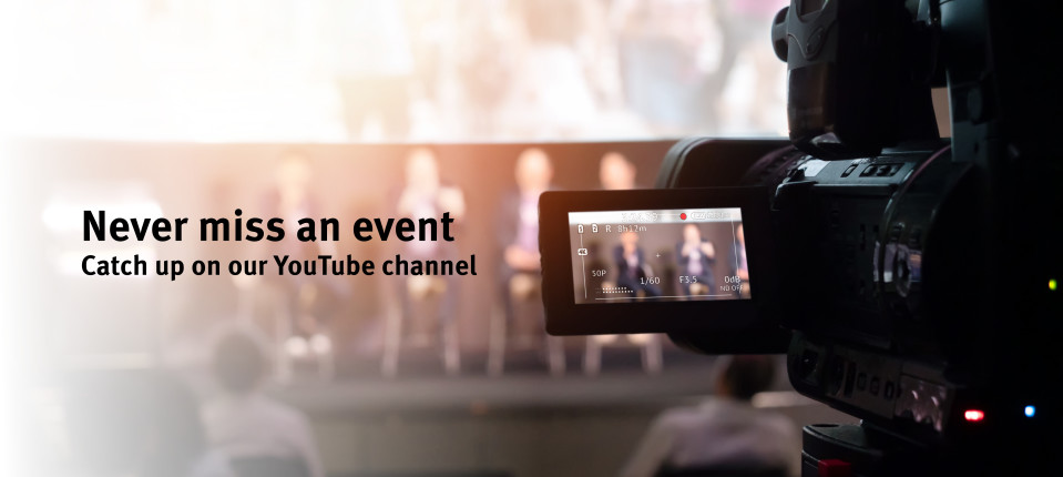 Video camera pointed at speakers at panel event