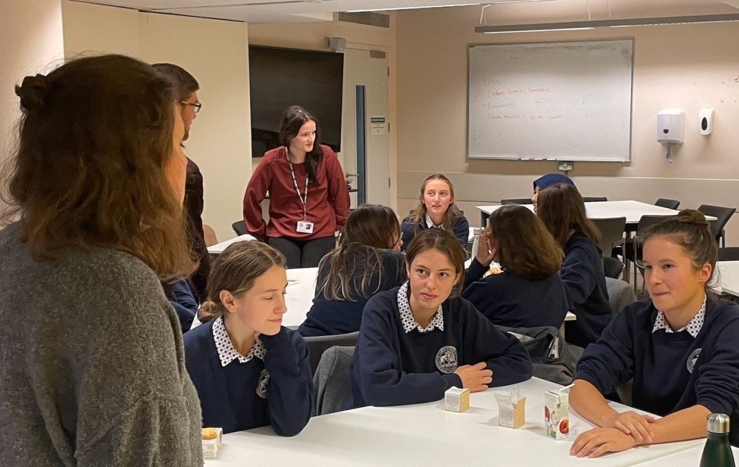 student talks with group of pupils