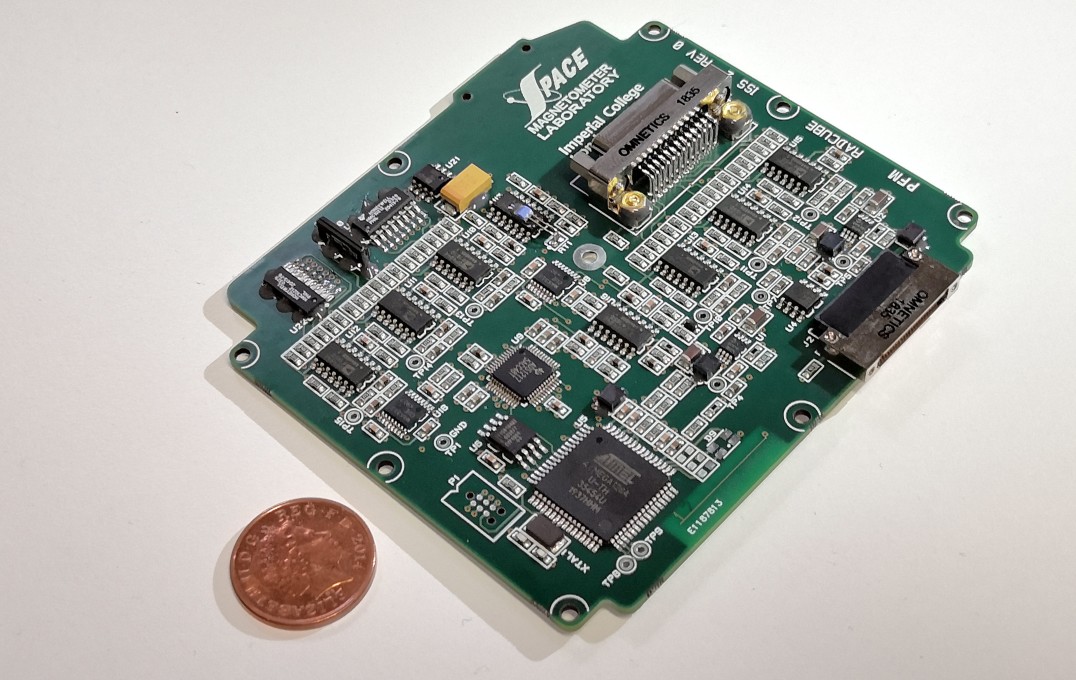 Circuit board next to 1p coin