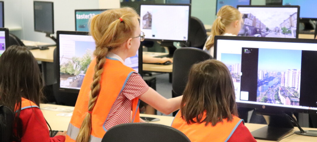 school girls sitting at desk on computers