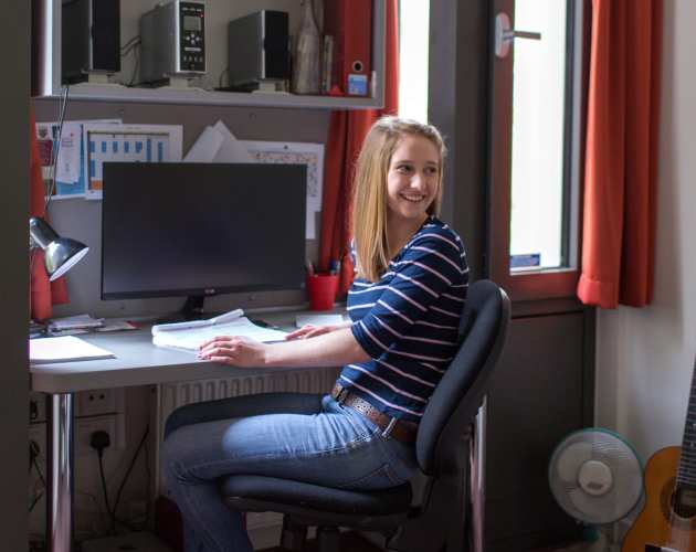 Student in her room in halls
