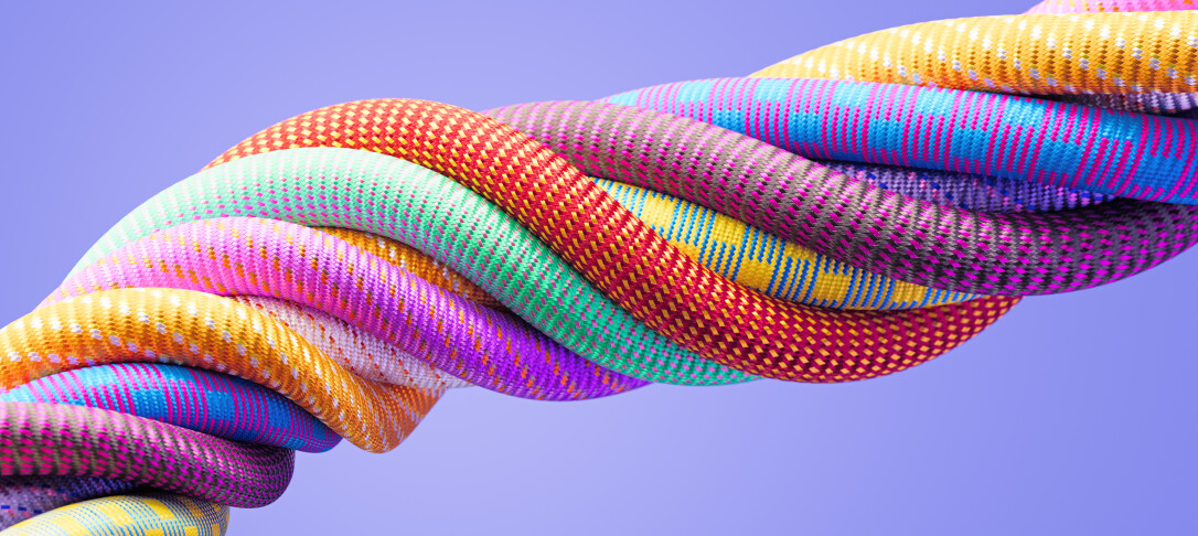Multi-coloured cords twisting around each other with a purple background