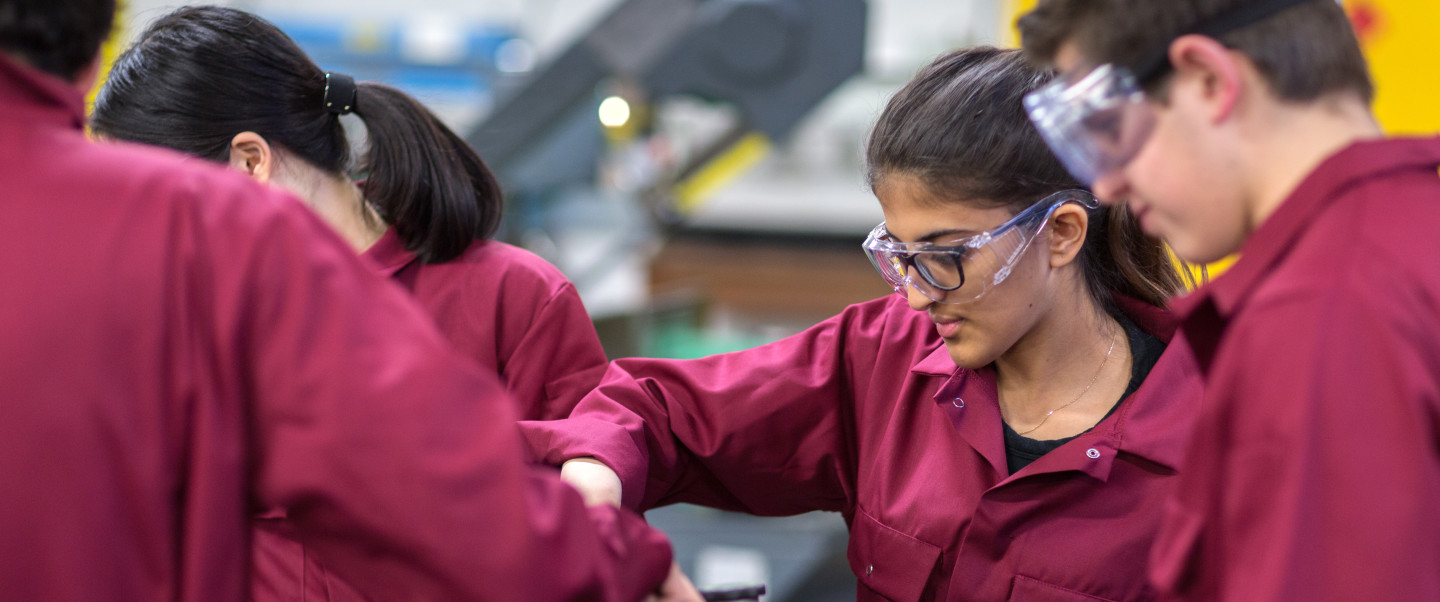 Students in lab handling engineering equipment 