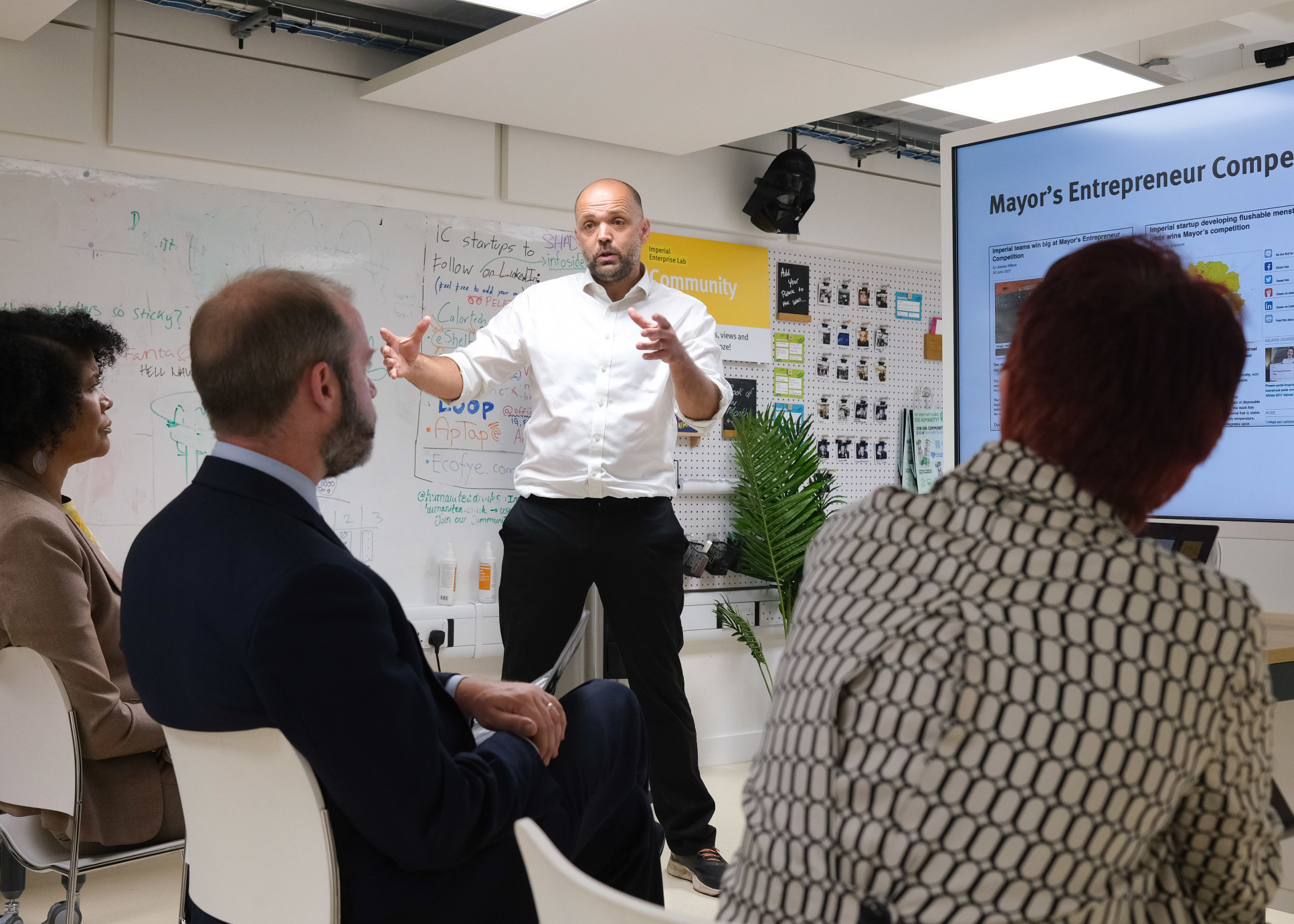 Man presenting to three people