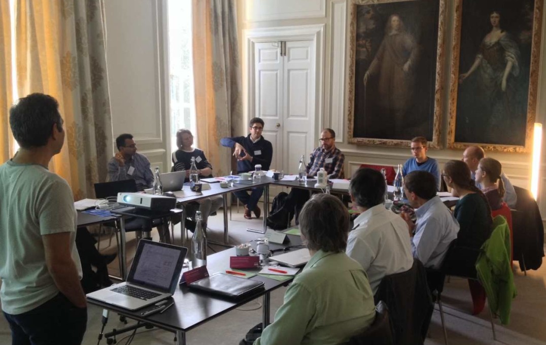 Delegates photographed during a presentation at Chicheley Hall at the inaugural meeting of the Red Lotus Project in 2016