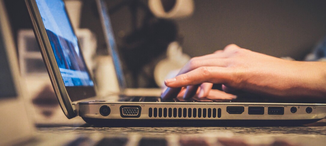 person typing on a laptop